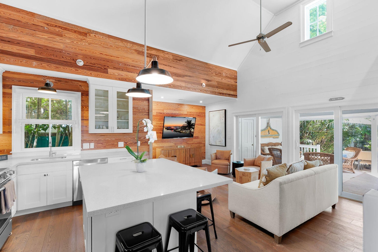 Kitchen island looking into the living room and through sliding glass doors to the lanai